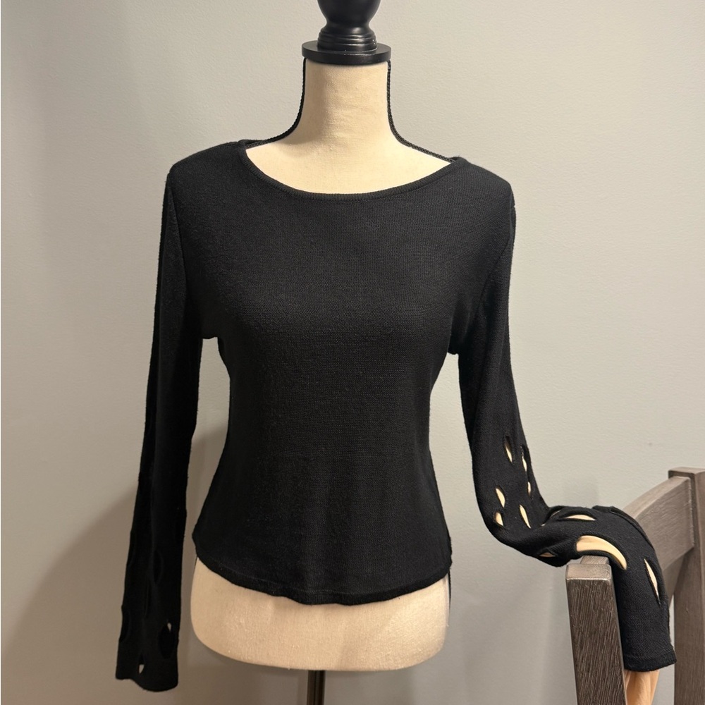 Black minimalist knit top with unique distressed sleeve detailing.